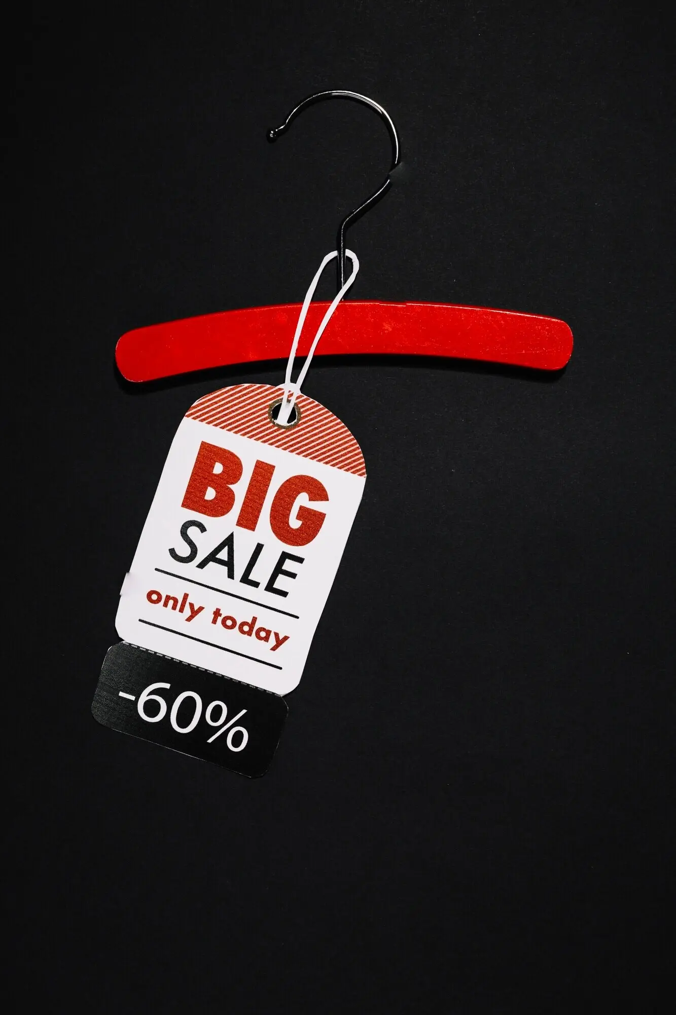 A red wooden hanger with a retro label.